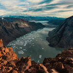 View of a fjord from top of cliff face looking down the pathway. Arctic cruises Arctic travel