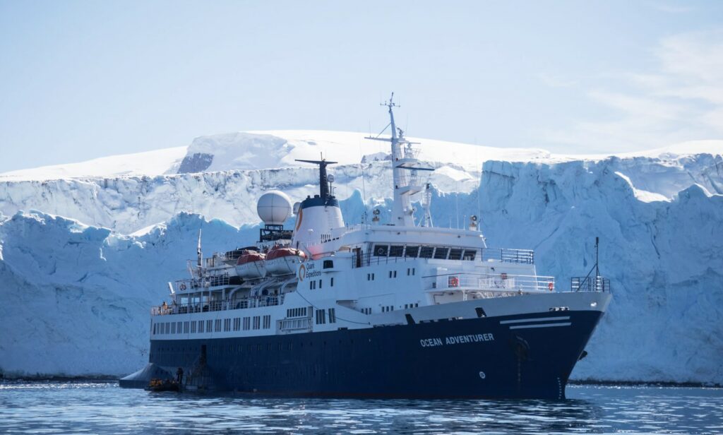 Polar cruise ship "Ocean Adventurer" in front of white ice walls in Polar region Polar cruise Travel Polar regions