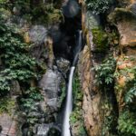 Waterfall on Azores islands flowing down steep cliff face. Cruise The Azores
