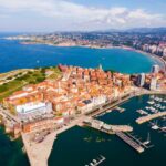 Aerial view of coastal city of Gijon - Spain and its port with red roofed buildings. Cruise Spain