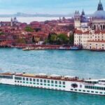 River cruise ship SS La Venezia cruising in the water of Venice with the city in the background. Venice cruise