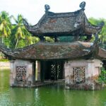 Buddha shrine in water of a lake. Sites from The Red River cruise itinerary. River cruise travel.