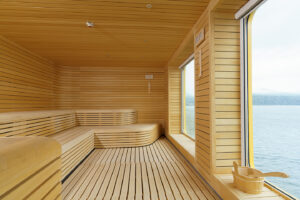 Sauna aboard the Ultramarine. Stunning wooden finish sauna room with floor to ceiling windows from where passengers can enjoy the amazing views of the Arctic and Antarctic regions.