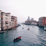 Main waterway Venice with buildings on either side and Chapel in the distance. Venice travel